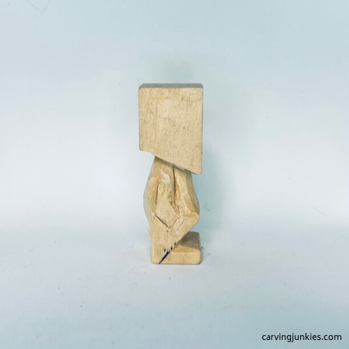 Progress photo of back of tiny wood carving