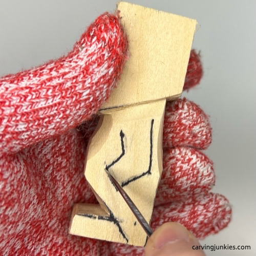 Starting to carve the arm on tiny wood carving man