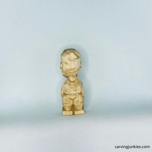 Back of unpainted tiny wood carving man