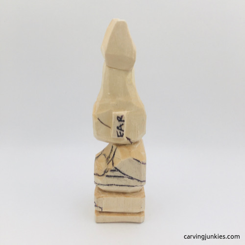 Left side of bikini on troll wood carving Left view of bikini on troll wood carving