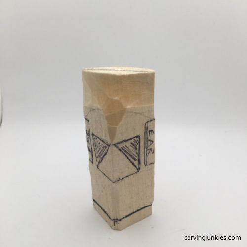 Wood shaved back on troll carving