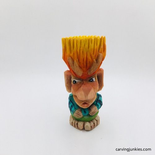 Front of painted wooden troll carving