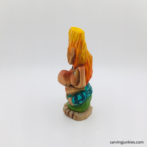 Left side of painted wooden troll carving