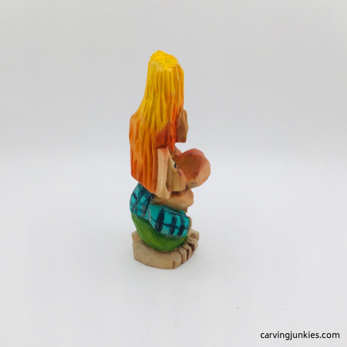 Right side of painted wooden troll carving