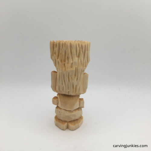 Back view of unpainted troll carving