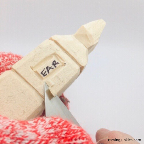 Shaping ear on troll wood carving Slicing wood around ear on troll wood carving