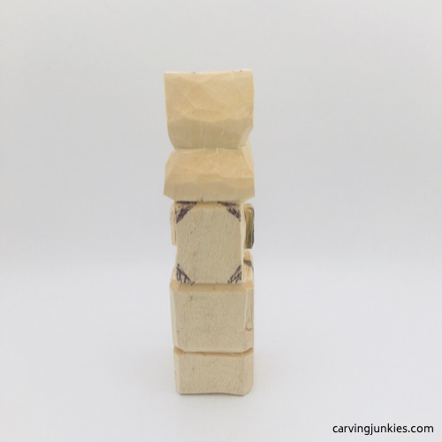 Back view of wood to remove on troll wood carving Back view of marked wood on troll wood carving