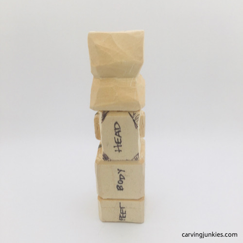 Drawn guidelines on head of troll wood carving Marking head of troll wood carving