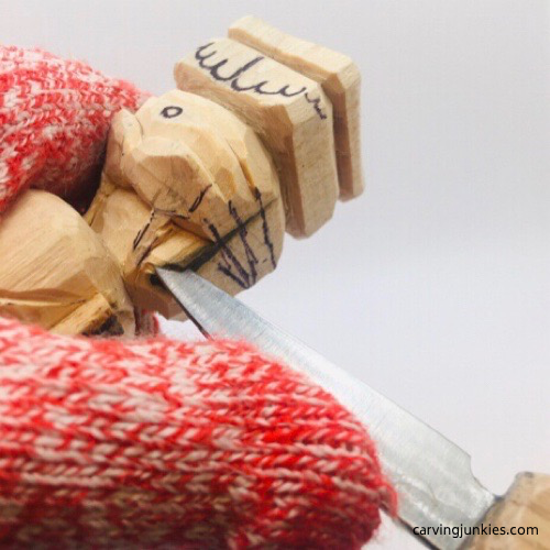 Refining arm on troll wood carving Shaping arm on troll wood carving