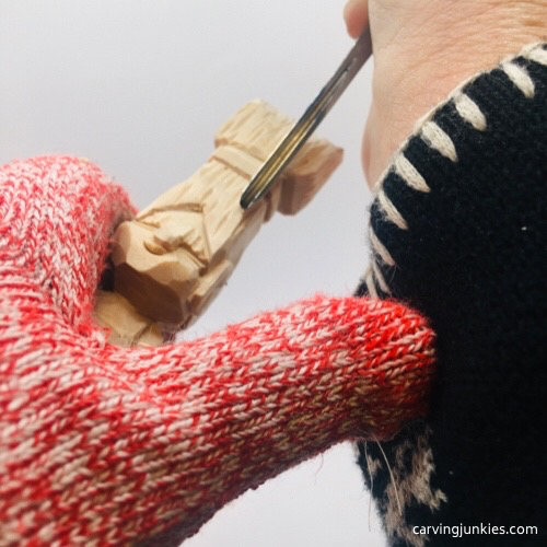 Carving hair on troll wood carving Gouge hold for troll wood carving