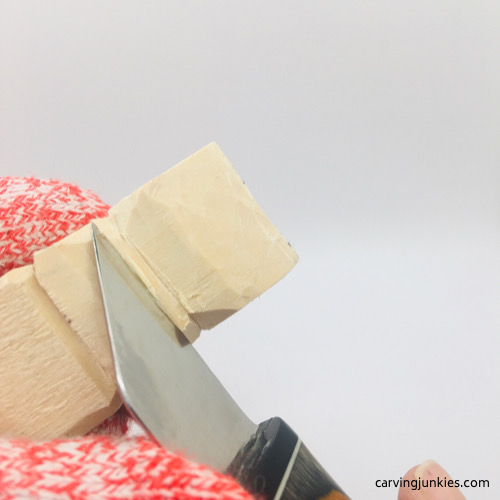 Helvie Boxcutter in use on troll wood carving Making angled cut on troll wood carving