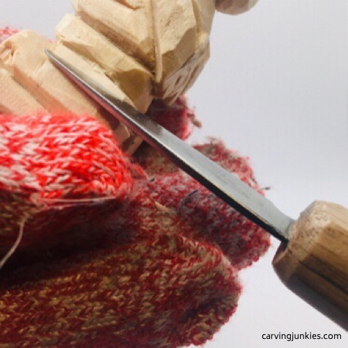 Carving feet on the troll wood carving Shaping feet on the troll wood carving