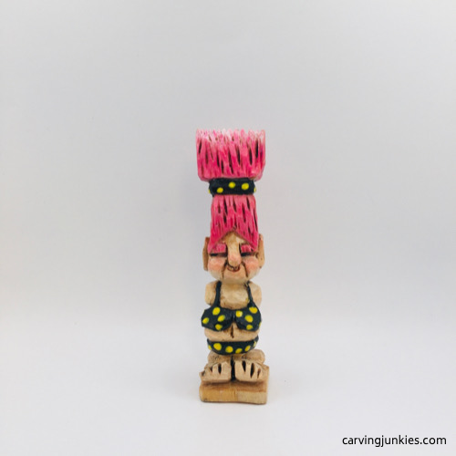 Front view of painted wooden troll front of painted troll wood carving