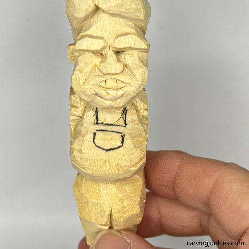 Drawn lines on wood carved man Details on wood carved man