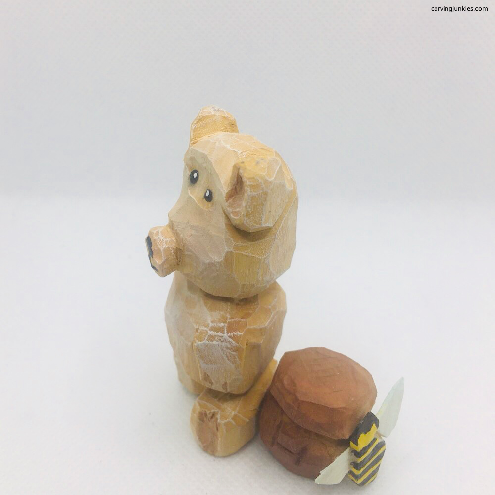 Left view of painted whittled bear