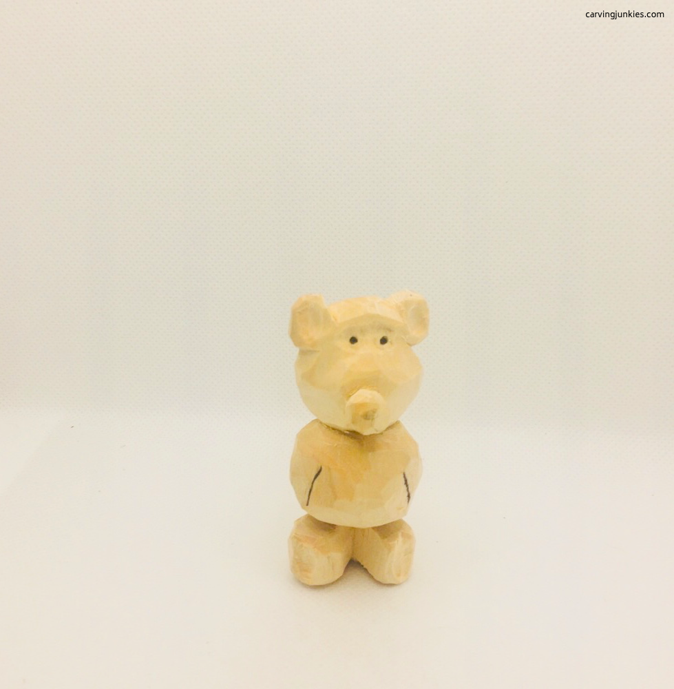 Cut ears on whittled bear