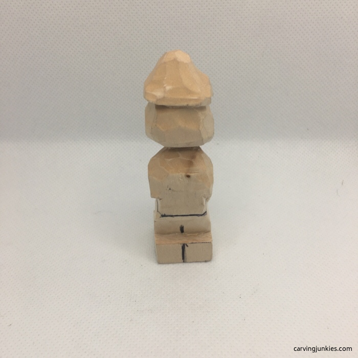 Back view of hippie wood carving