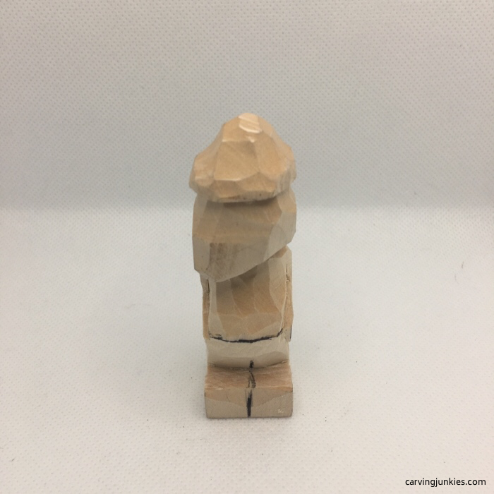 Cut arms in front of wood carving