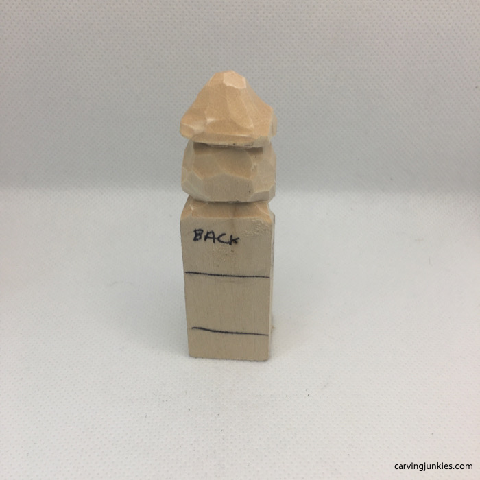 Back view of hippie wood carving