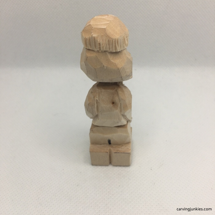 Back view of beanie on wood carving