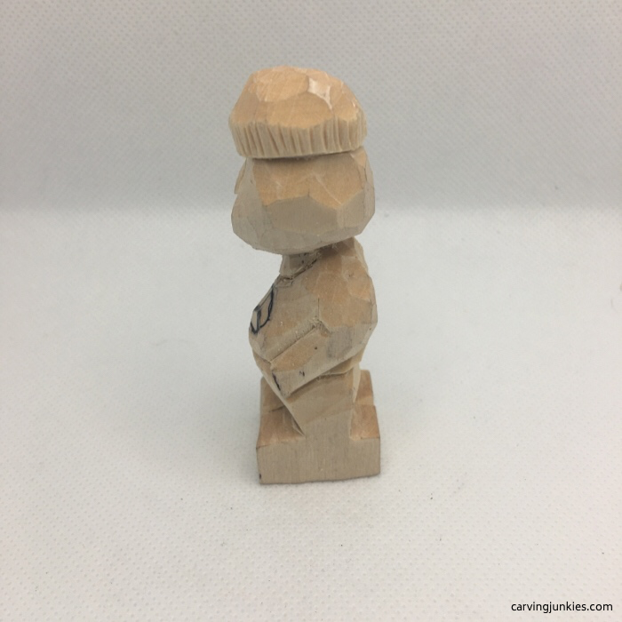 Beanie from left on wood carving