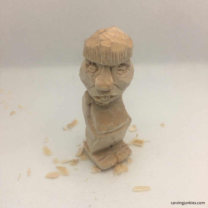 Droopy eyelids added to wood carving