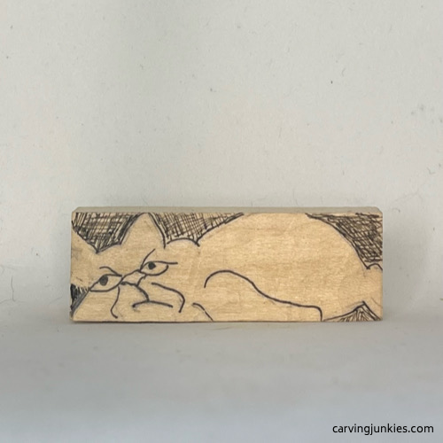 Details are drawn on cat whittling Body is sketched for whittled cat carving