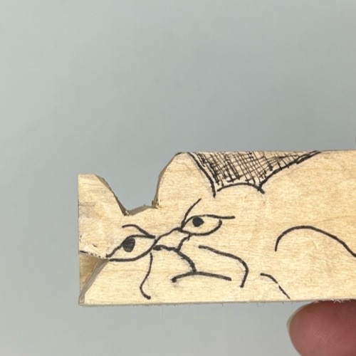 Head is separated on cat whittling Ears are separated on whittled cat