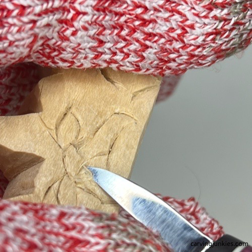 Creating face details on cat whittling Shaving wood off face of whittled cat