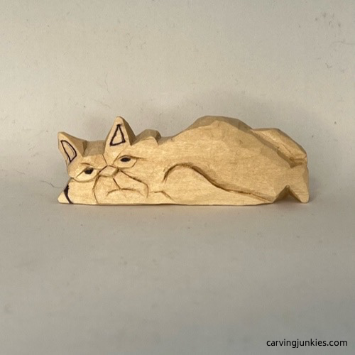 Marked wood for removal on cat whittling Marking wood to remove on face of whittled cat