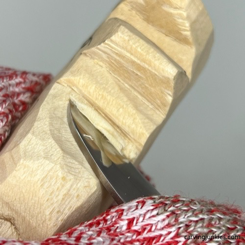 Shaping middle of cat whittling Curving middle of whittled cat