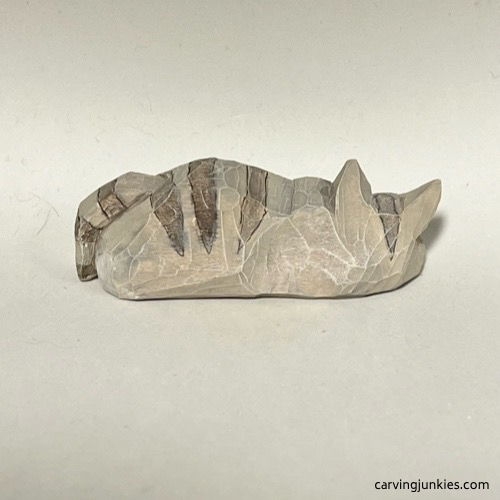 Back side of of painted cat whittling Rear view of painted whittled cat