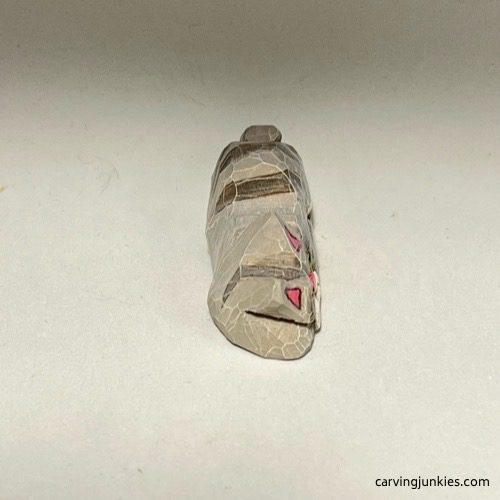 Front head view of painted cat whittling Top view of painted whittled cat