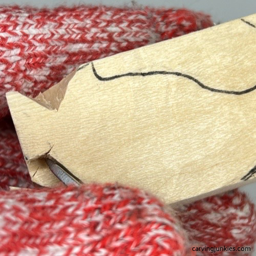 Carving back paw on cat whittling Separating paws on whittled cat