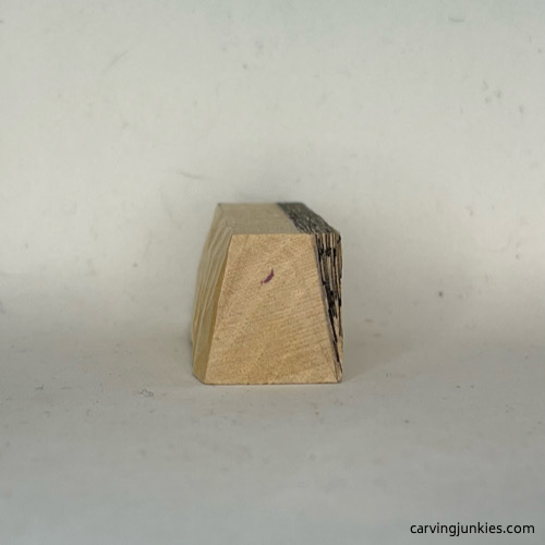 One side is carved on cat whittling Progress photo of whittled cat