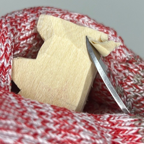 Carving back on cat whittling Shaping back head of whittled cat