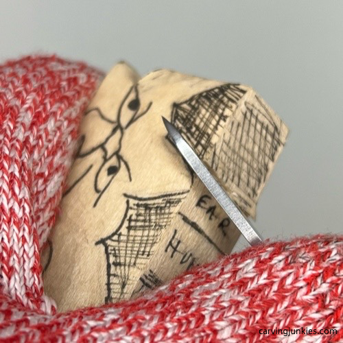 Separating head on cat whittling Making a stop cut on whittled cat