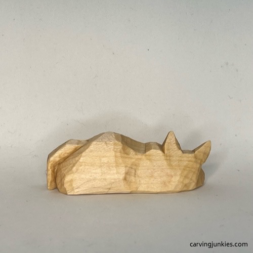 Back view of unpainted cat whittling Back of unpainted whittled cat
