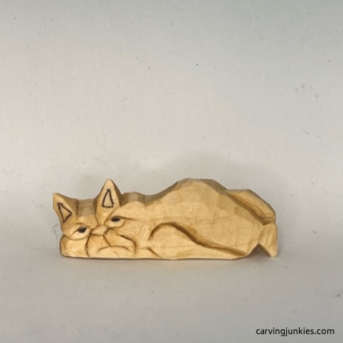 Front view of unpainted cat whittling Front of unpainted whittled cat