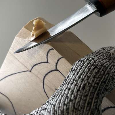 Starting to remove wood on whittled fish