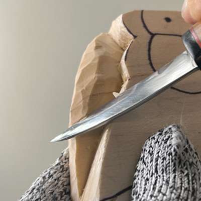 Removing wood in layers on whittled fish