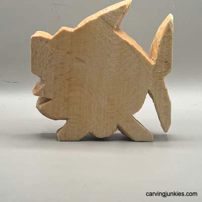Back of unpainted fish carved from wood