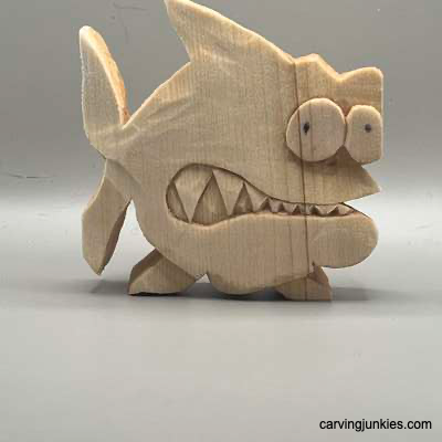 Unpainted front of wood carved fish caricature