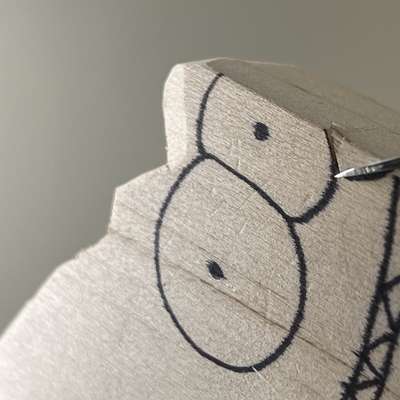 Making a V-cut on whittled fish