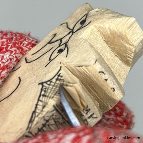Removing wood from middle of cat whittling Carving the middle of a whittled cat