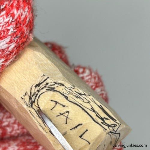 Carving tail on cat whittling Separating tail on whittled fox