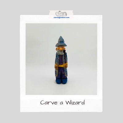 Wizard wood carving with a blue robe and holding a staff