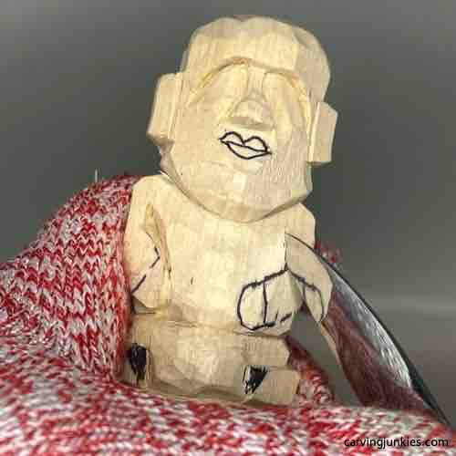 Carving the arm on wood carved Buddha