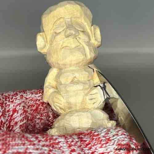 Carving cloak on wood carved Buddha