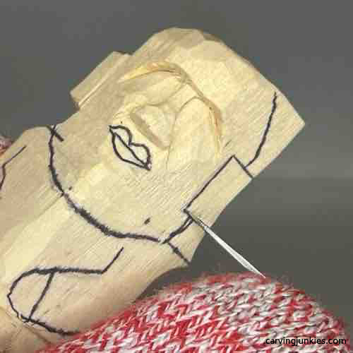 Separating ear on wood carved Buddha